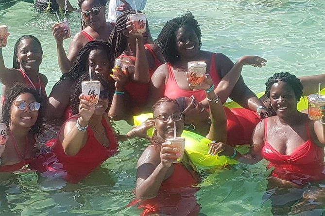 Party Boat in Punta Cana - Booze Cruse - Bavaro Beach stop: crystal-clear water, parasailing nearby, and a good first swim