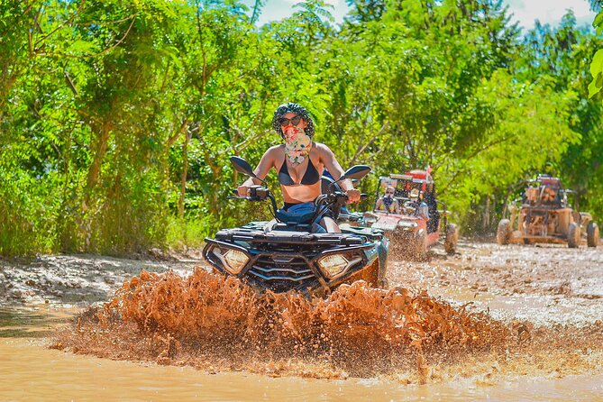 Punta Cana ATV Adventure - Playa Macao beach stop: sand, palms, and surfer energy